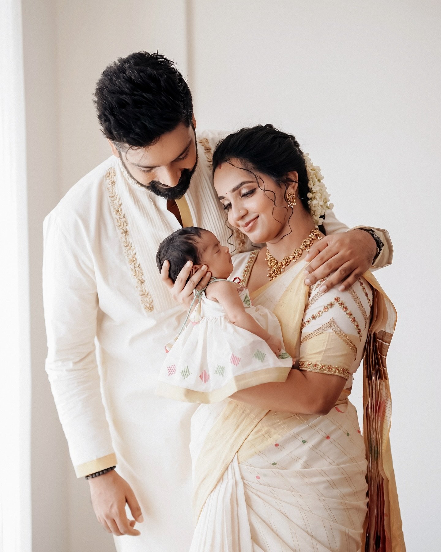 Parents gazing at their newborn daughter