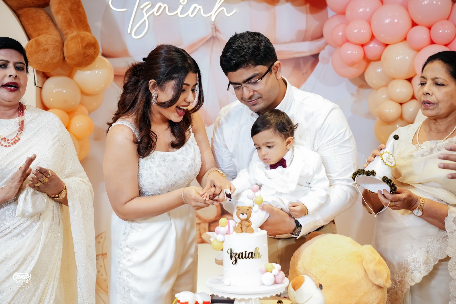 A family celebrating their baby's first birthday