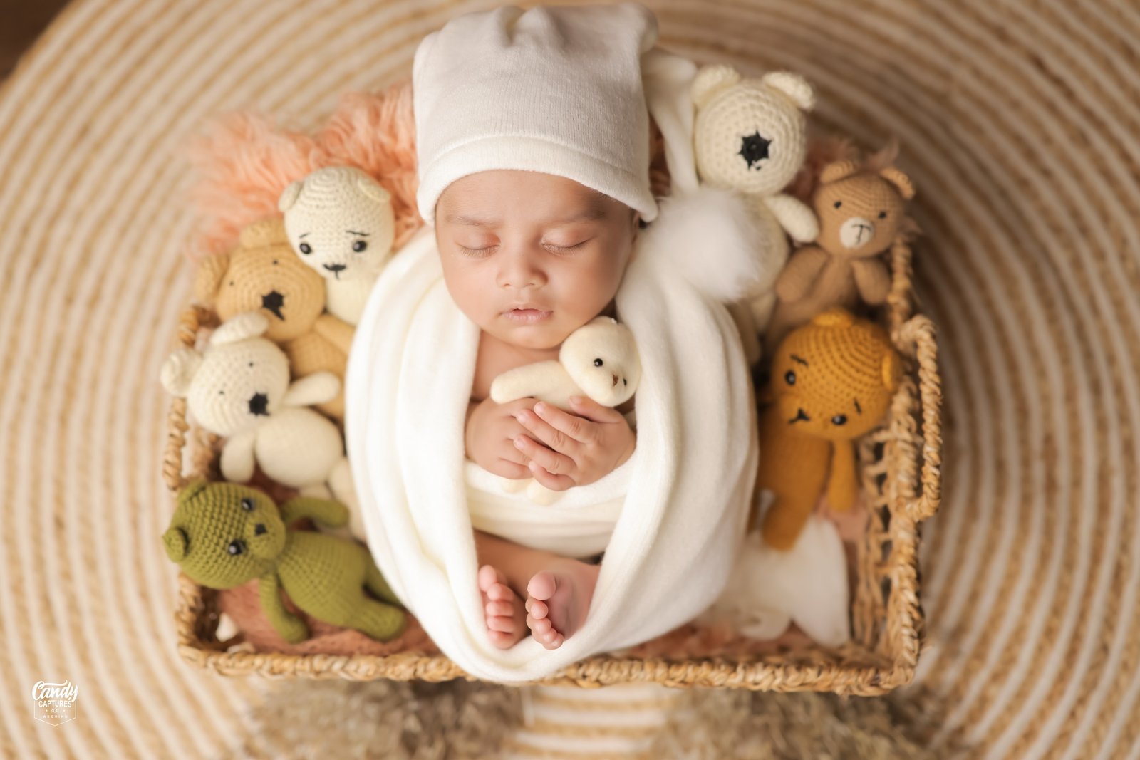 A sleeping newborn tucked among handmade toys